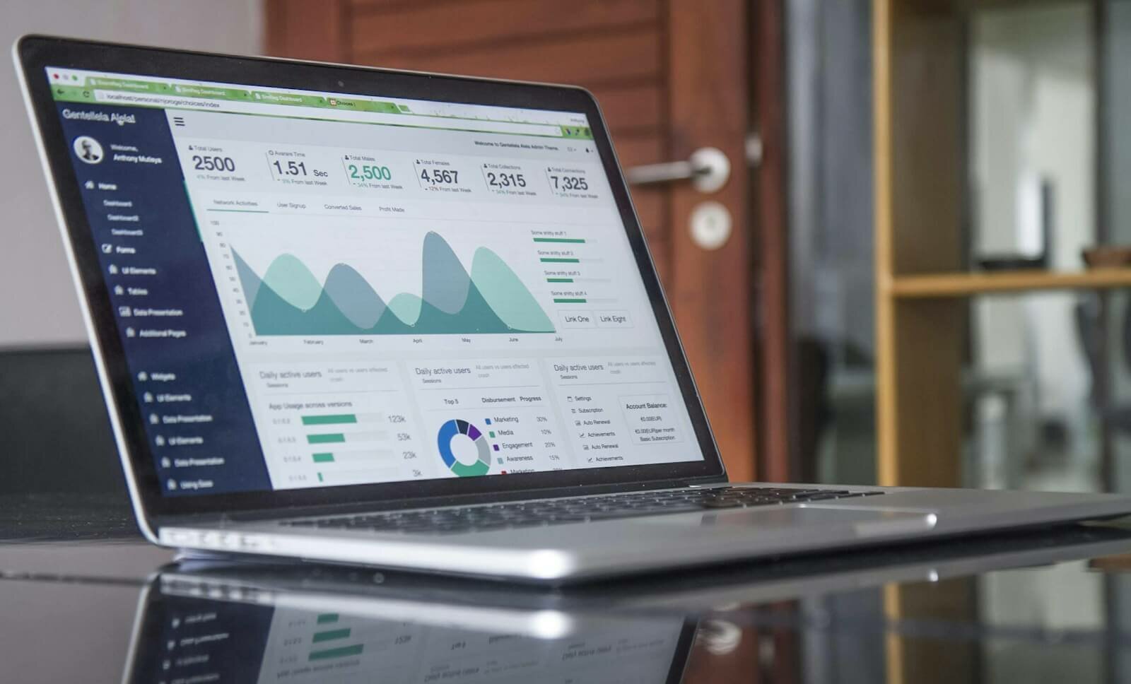 laptop computer on glass-top table